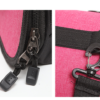 Close-up of pink cat carrier bag showing sturdy zippers and secure strap clip