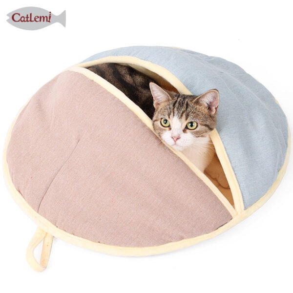 1a33445944fcbdd30d1bc97f9239 Cat resting in cozy, dome-shaped cat bed with beige and blue fabric on white background