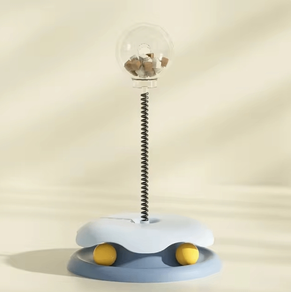 Interactive cat toy with blue base, spring wand, treat dispenser, and two yellow balls