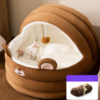 White cat sleeping in a cozy brown bear-shaped cat bed with soft plush interior.