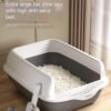 Extra large cat litter box with high anti-sand belt, white scoop, modern room setting