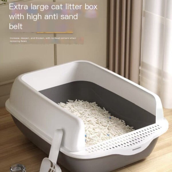 Extra large cat litter box with high anti-sand belt, white scoop, modern room setting