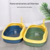 Semi-enclosed cat litter boxes in yellow with blue and green bases, matching scoops included