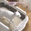 Cat in litter box with widened anti-leakage sand pedal and pellet litter