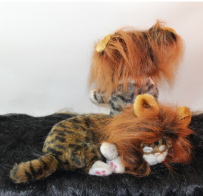 Two plush cat toys with faux fur manes on black and white background, luxury cat accessory