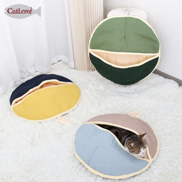d118c24c4ba0af5db4c8d6d1b575 Cozy round cat beds in assorted colors, one with a cat inside, on a white rug.