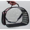 Clear window cat carrier bag with paw print design and ventilation holes, hand-held